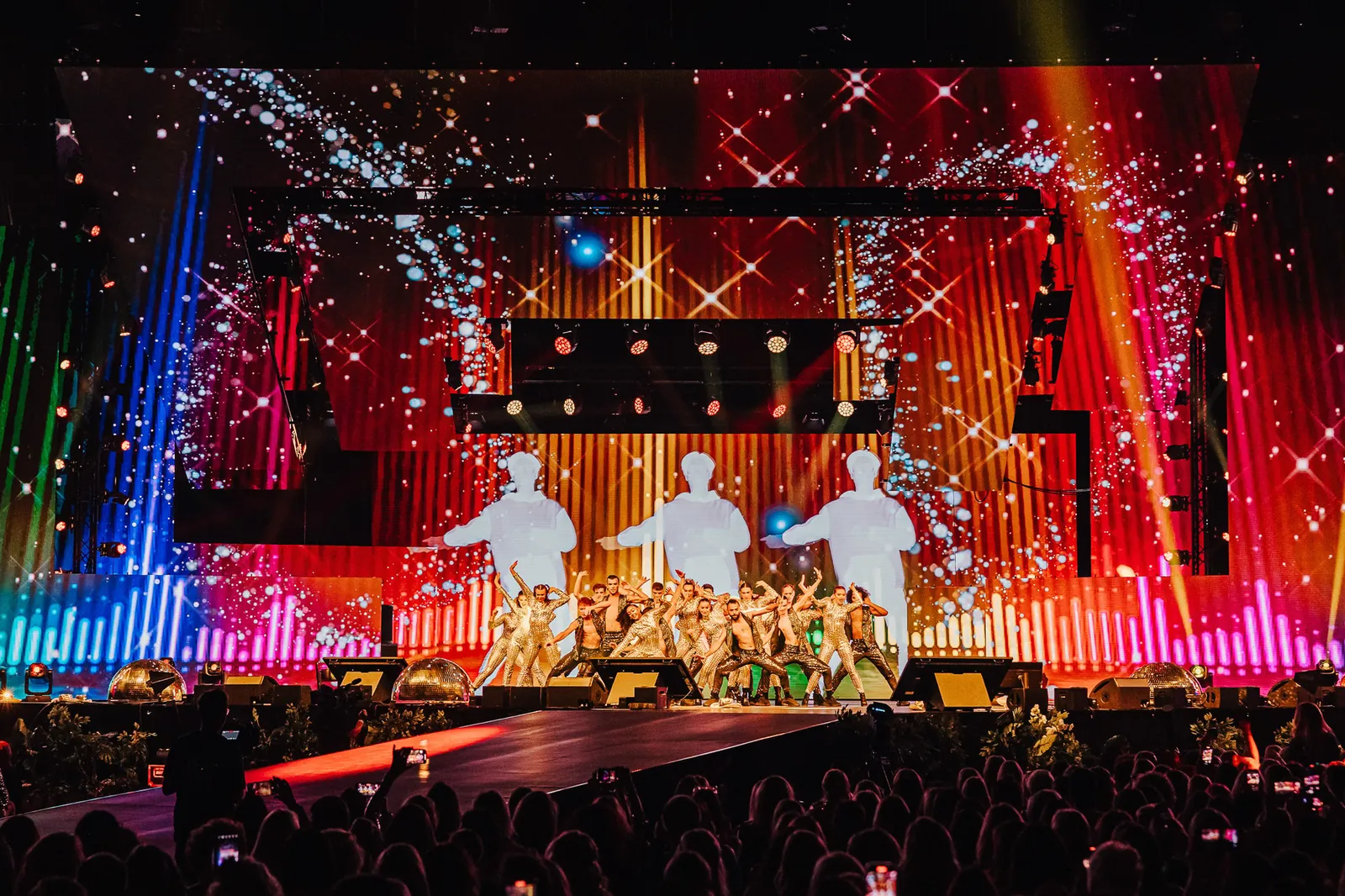 Performers on the Tropic conference runway beneath a vast LED screen wall