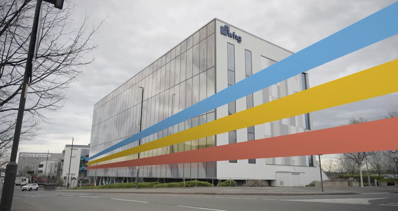 Walsall Housing Group conference film still: the whg building with coloured ribbon graphics